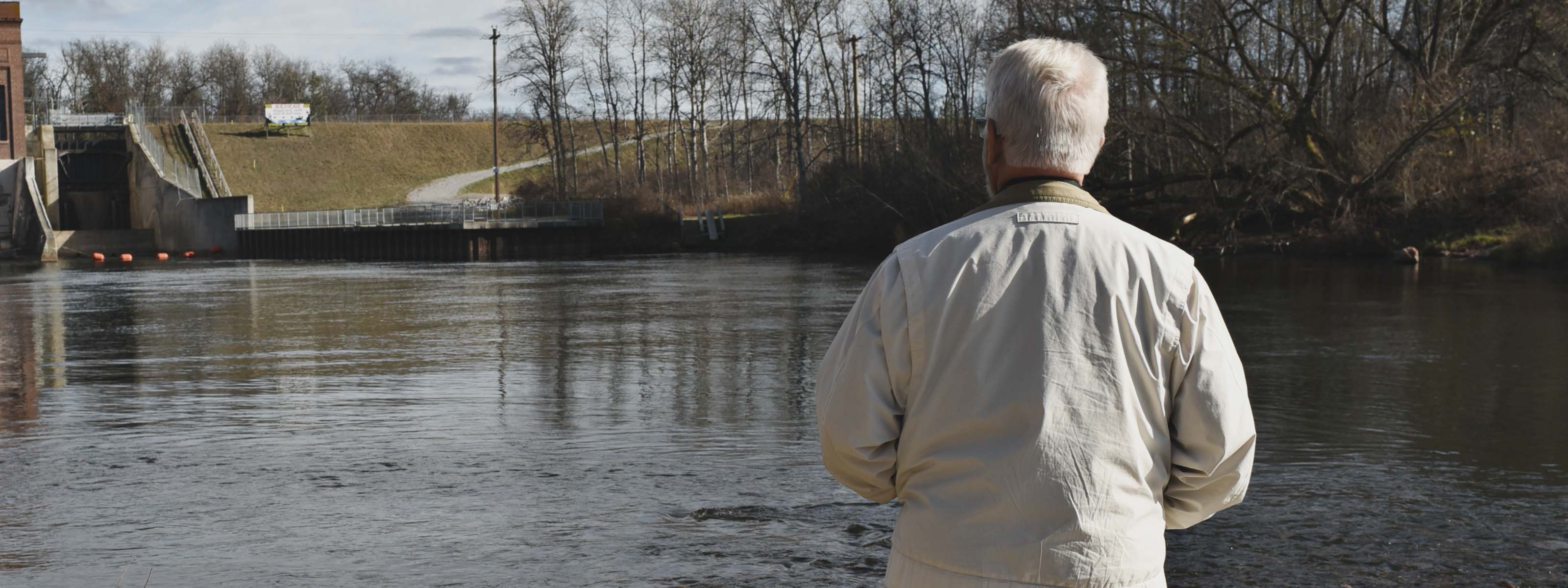 Old man looking at river